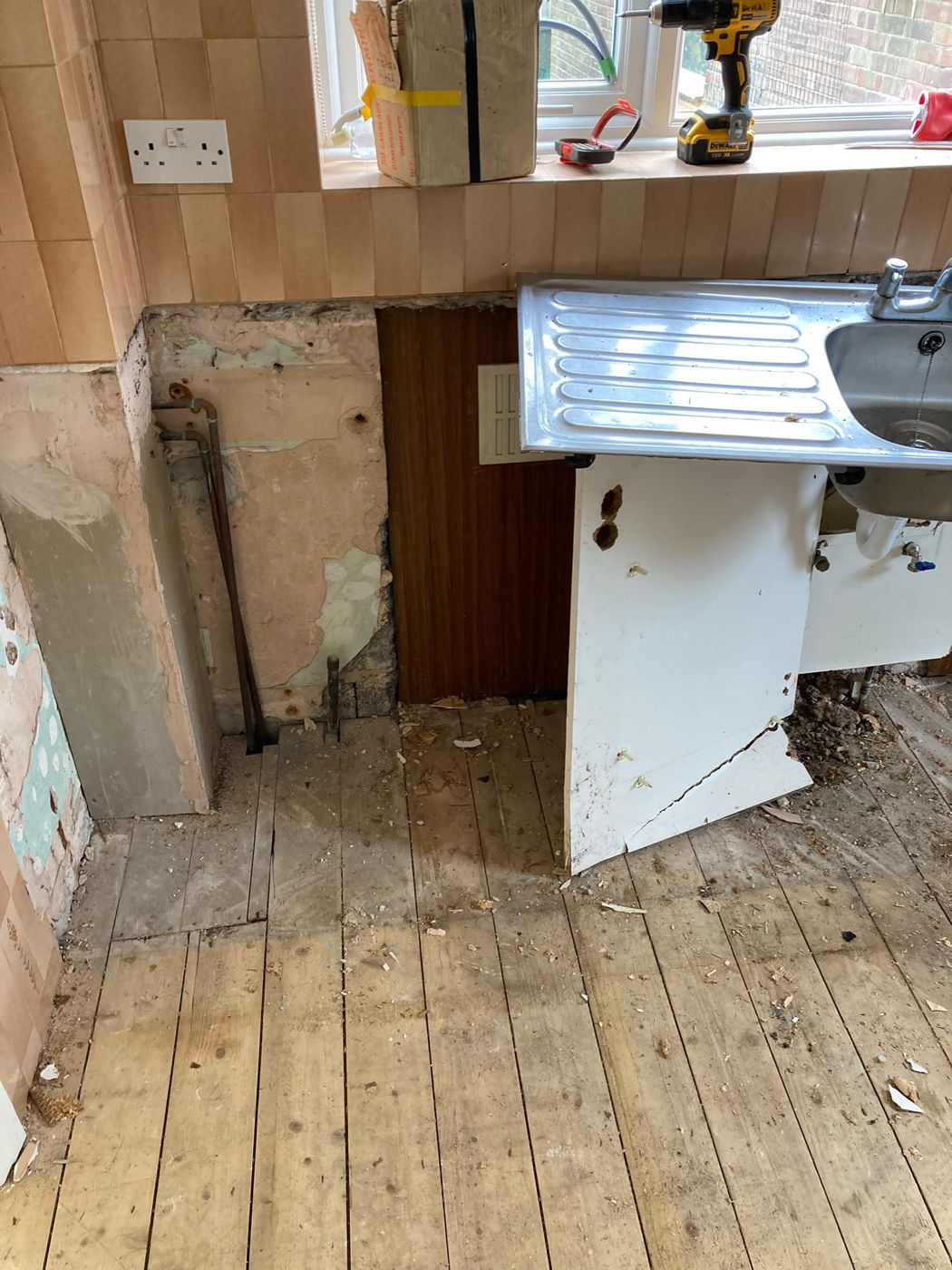 An old kitchen stripped out with the waste removed